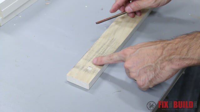 Planer snipe visible on the end of a board after running through a thickness planer, shown using a carpenter pencil rubbed on its side to highlight high and low spots