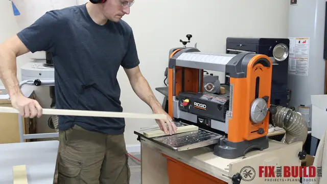 Feeding a sacrificial board through a RIDGID lunchbox planer ahead of the real workpiece to prevent planer snipe