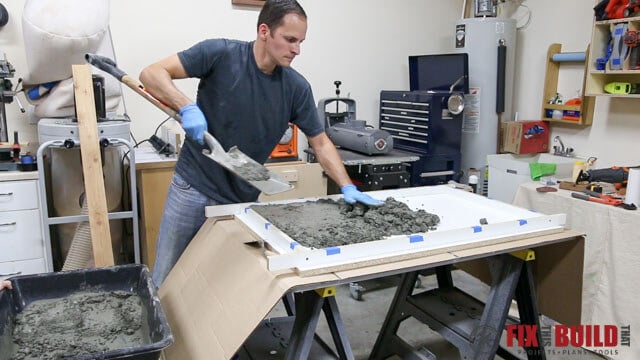 filling concrete form for outdoor coffee table