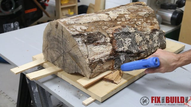 prepping wood to mill firewood into lumber using a sled on bandsaw