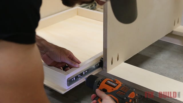 installing pull out trays on a base cabinet