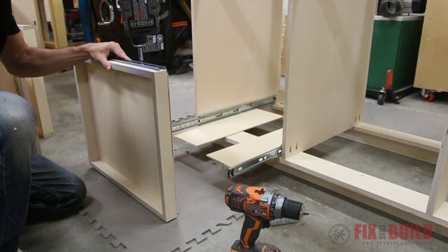 installing pull out trays on a base cabinet