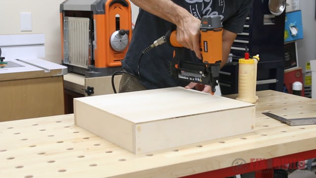 nailing on the bottom of a drawer with a brad nailer