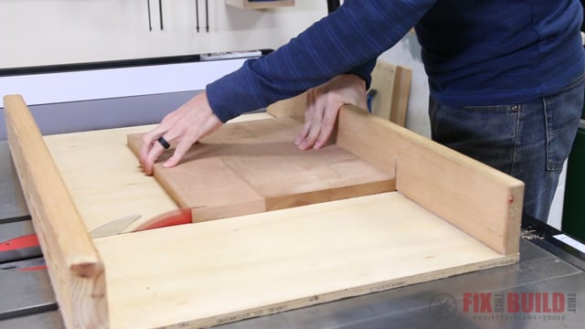 cutting a step stool top to size on a table saw cross cut sled