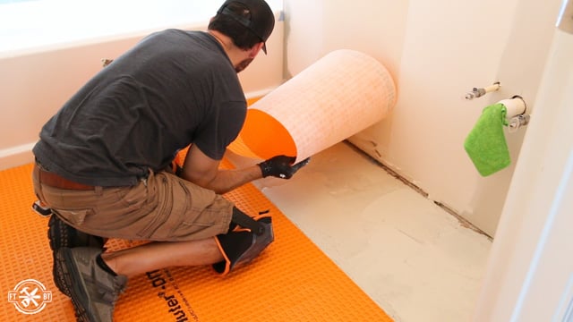 laying a smaller sheet of ditra on the mortar