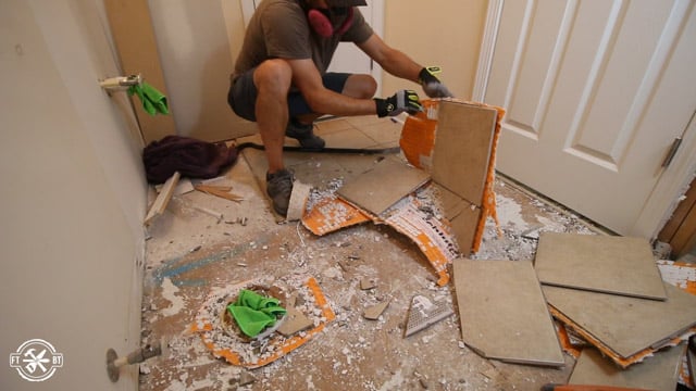 ripping up old tile floor in bathroom