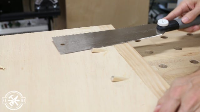 sawing off the top of wood plugs using pull saw