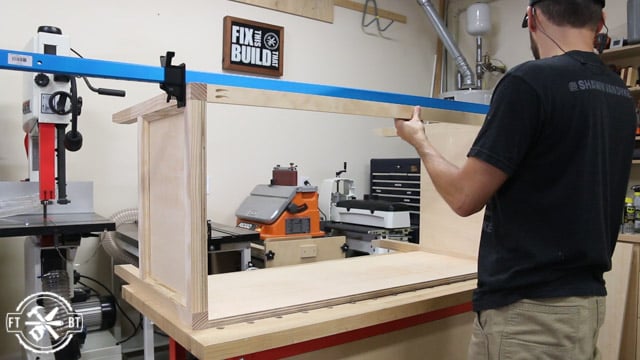 screwing the front stretcher on the wood desk