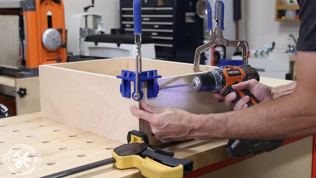 using corner clamp to screw wood drawers together