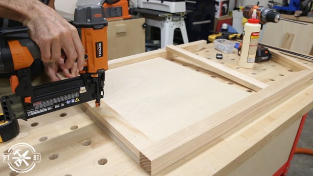 attaching top and bottom trim piece with glue and brad nails