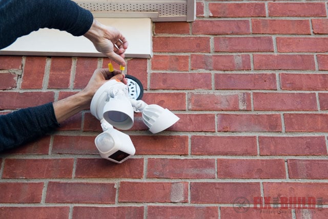 connecting wires for ring floodlight on red brick wall