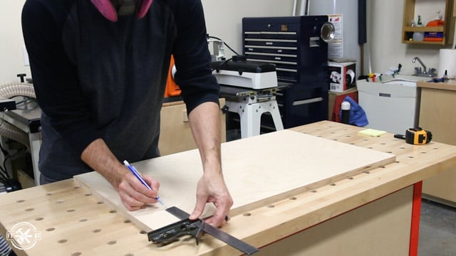 measuring piece of wood on table
