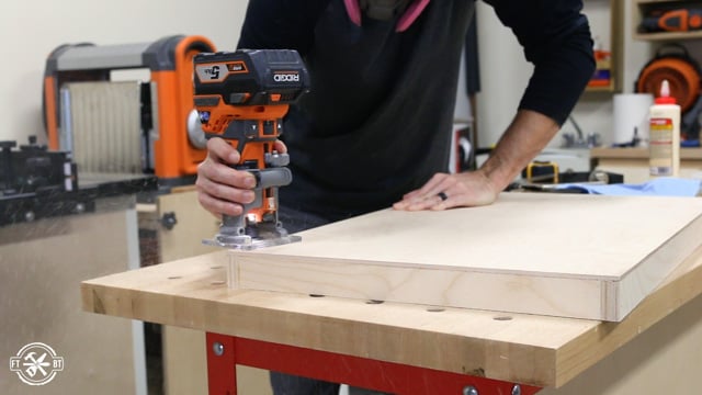 using router with chamfer bit to take off bottom edge of wood drawer