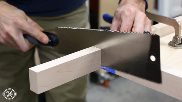 cutting extra wood trim off with a pull saw