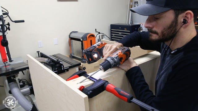 Kreg corner clamp holding wood together while screwing pieces together
