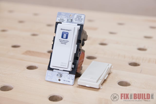 smart light switch with extra almond cover on wooden table