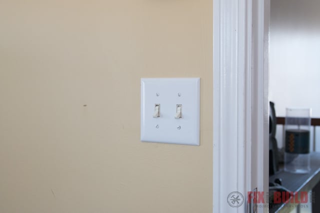 light switches on a yellow wall
