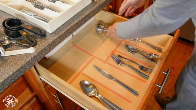 putting craft tape in wooden kitchen drawer for layout