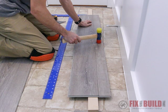 snapping vinyl plank with mallet