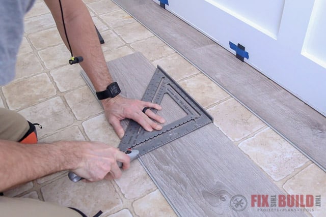 scoring vinyl plank flooring with a utility knife