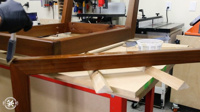 applying finish to chair
