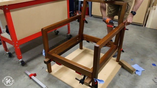 screwing the chair back into the arm of chair