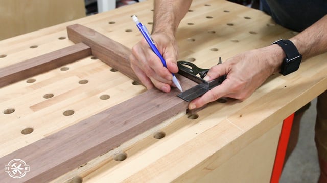 measuring to add dowels to wooden side