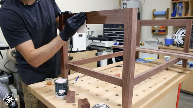 applying finish to walnut coffee table