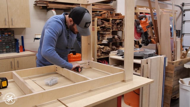 screwing lower shelf into place on outfeed table