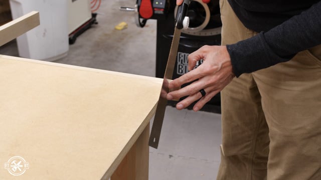 using pull saw to cut off extra trim