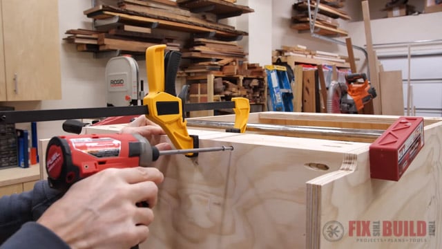 adding screws to the cabinet base