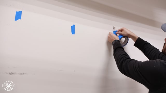 finding studs with magnets and marking with tape