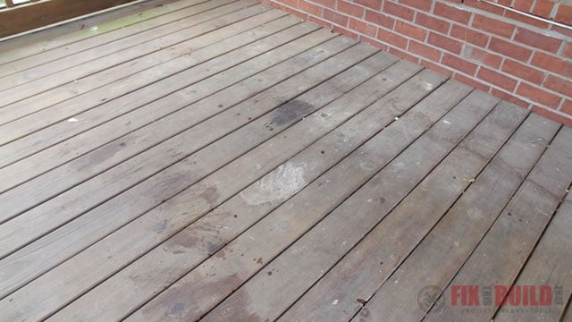 weathered wooden deck with stains