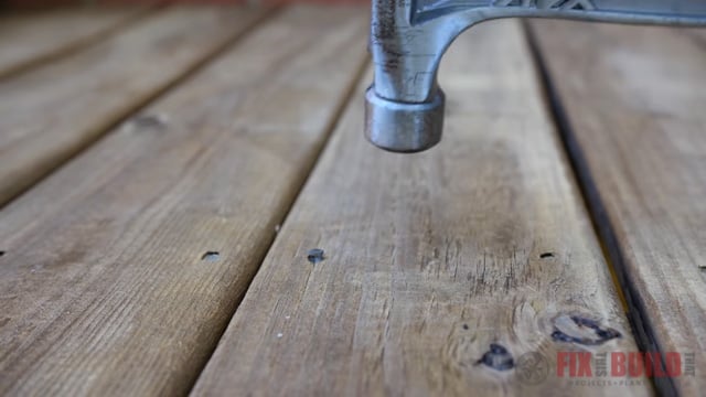 driving nails into deck boards