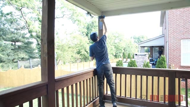 brushing stain onto posts