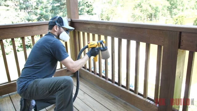 spraying spindles on deck with stain