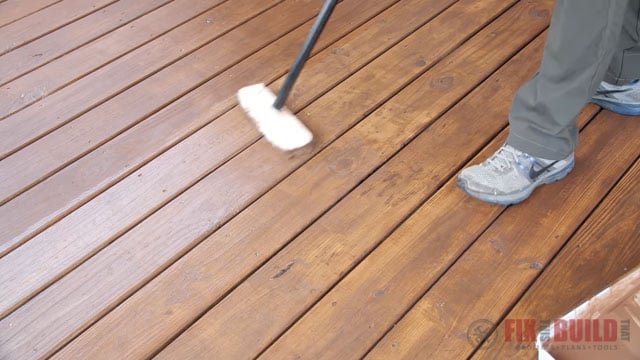 putting second coat of stain on deck