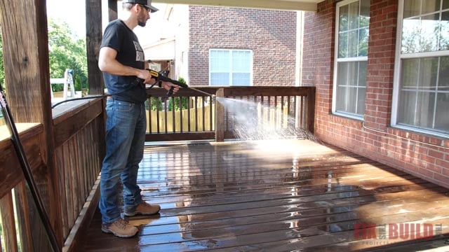 spraying cleaner on deck