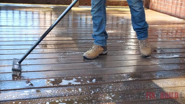 scrubbing deck with deck brush
