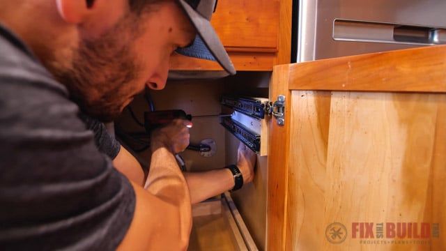 screw pull out tray into the side of cabinet