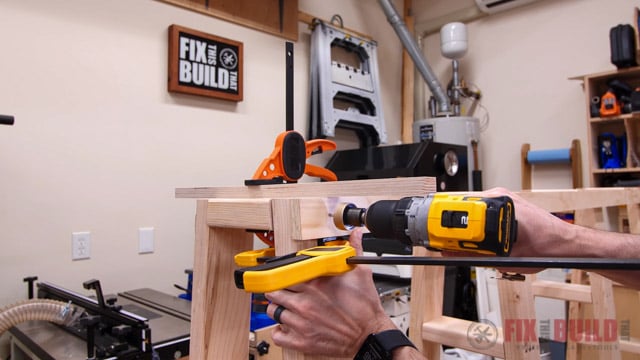 attaching plywood strips to side of lumber cart