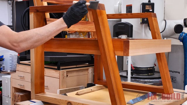 applying finish to wooden chair