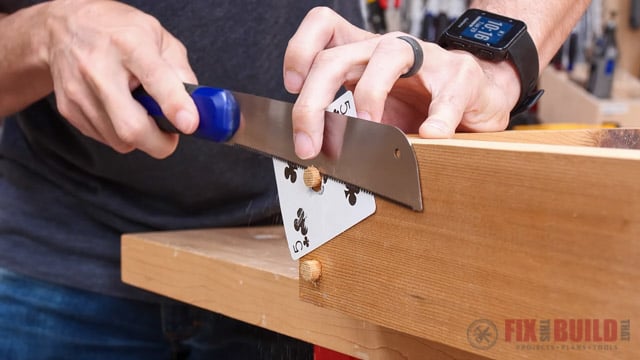 flush cutting a wooden plug with a card behind it