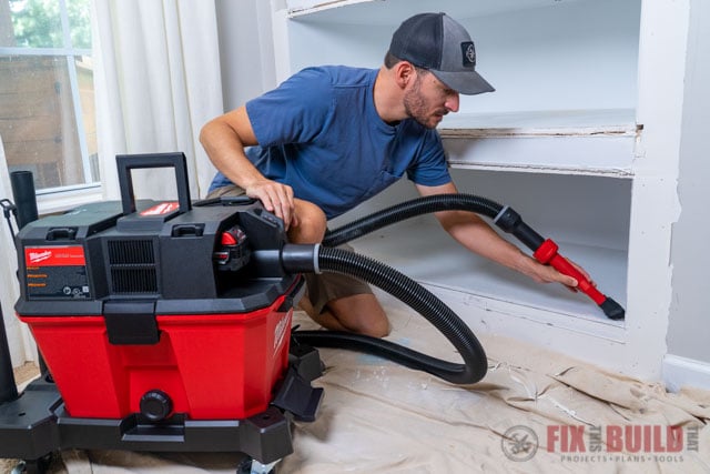 vacuuming built in shelves with shop vac